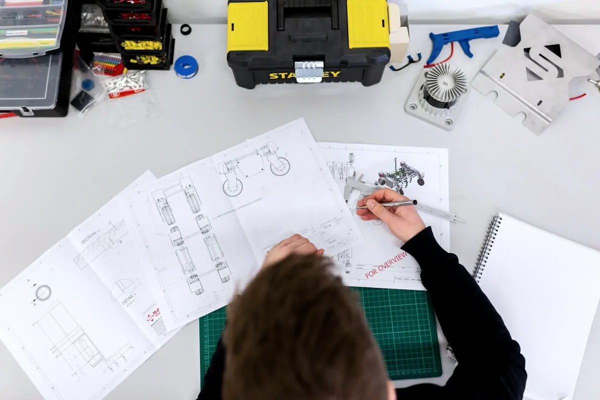 Engineer marking up technical drawings during design coordination